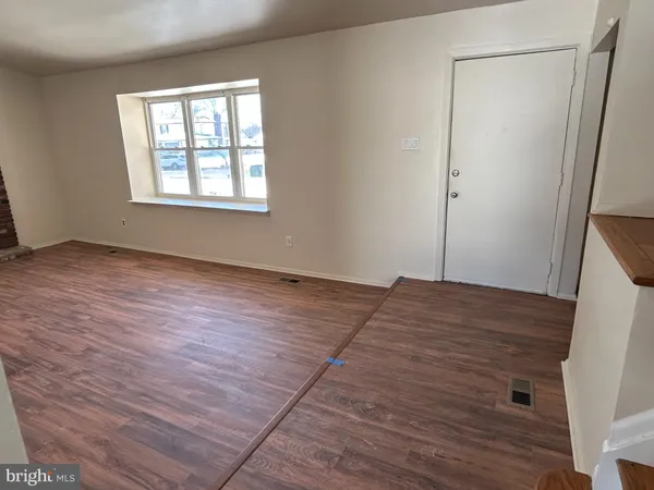 an empty room with wooden floor and closet