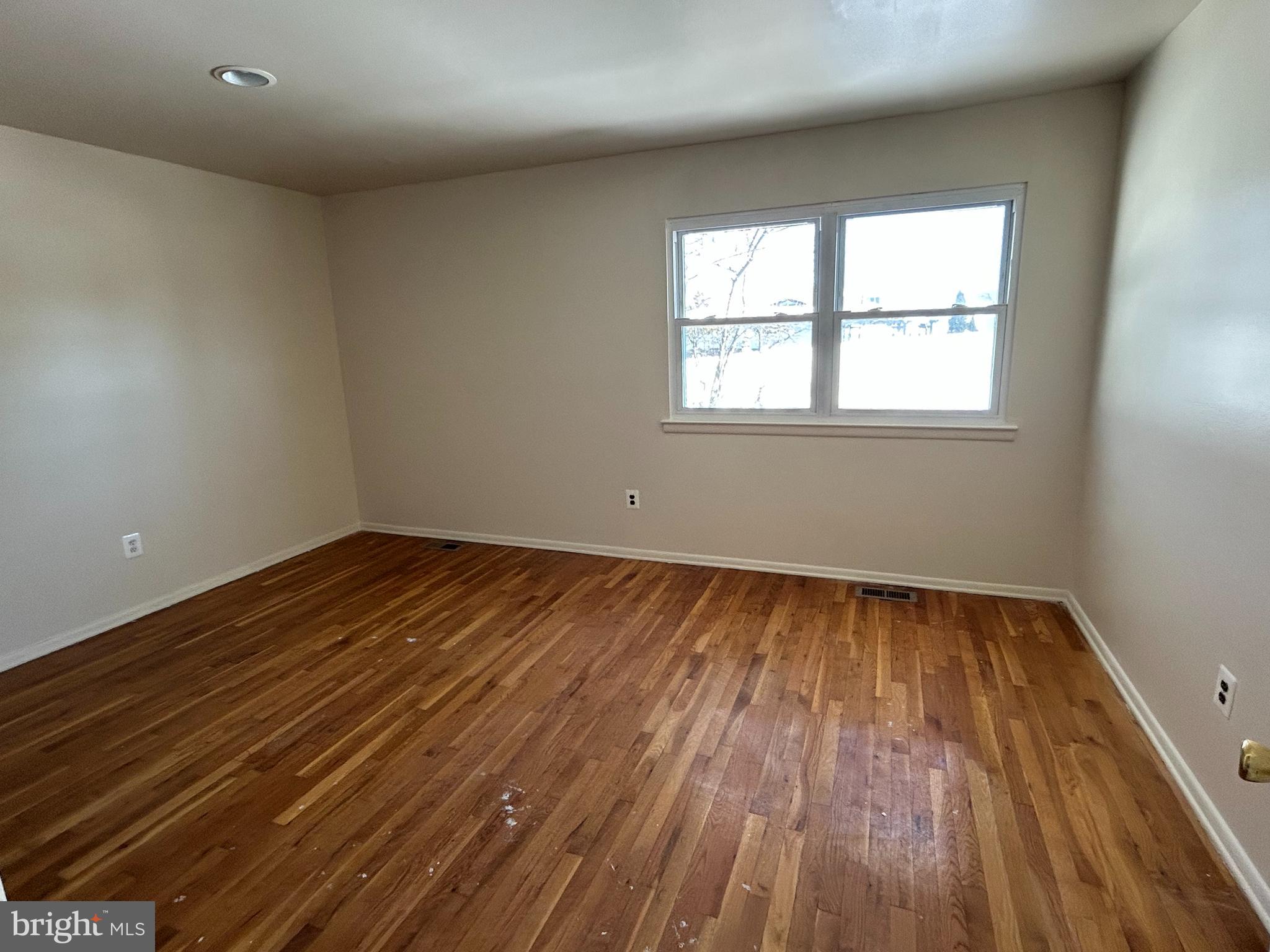 60 Stonegate Drive Eastampton, NJ 08060 - Photo 7 of 13 an empty room with wooden floor and windows