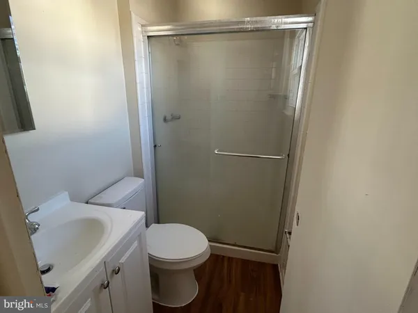 a white toilet sitting next to a shower