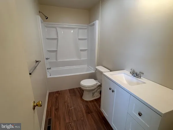 a bathroom with a sink toilet a mirror and shower