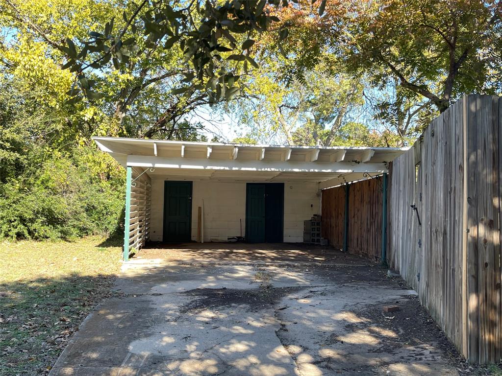 2203 Fowler Drive Denton, TX 76209 - Photo 18 of 18 a view of a house with a tree and wooden fence