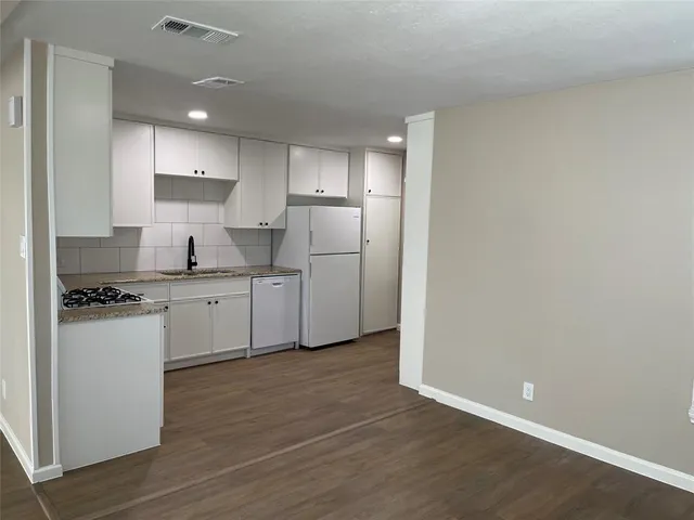 a kitchen with stainless steel appliances a refrigerator sink and cabinets