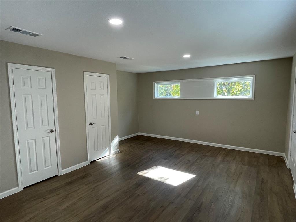 2203 Fowler Drive Denton, TX 76209 - Photo 9 of 18 an empty room with wooden floor and windows