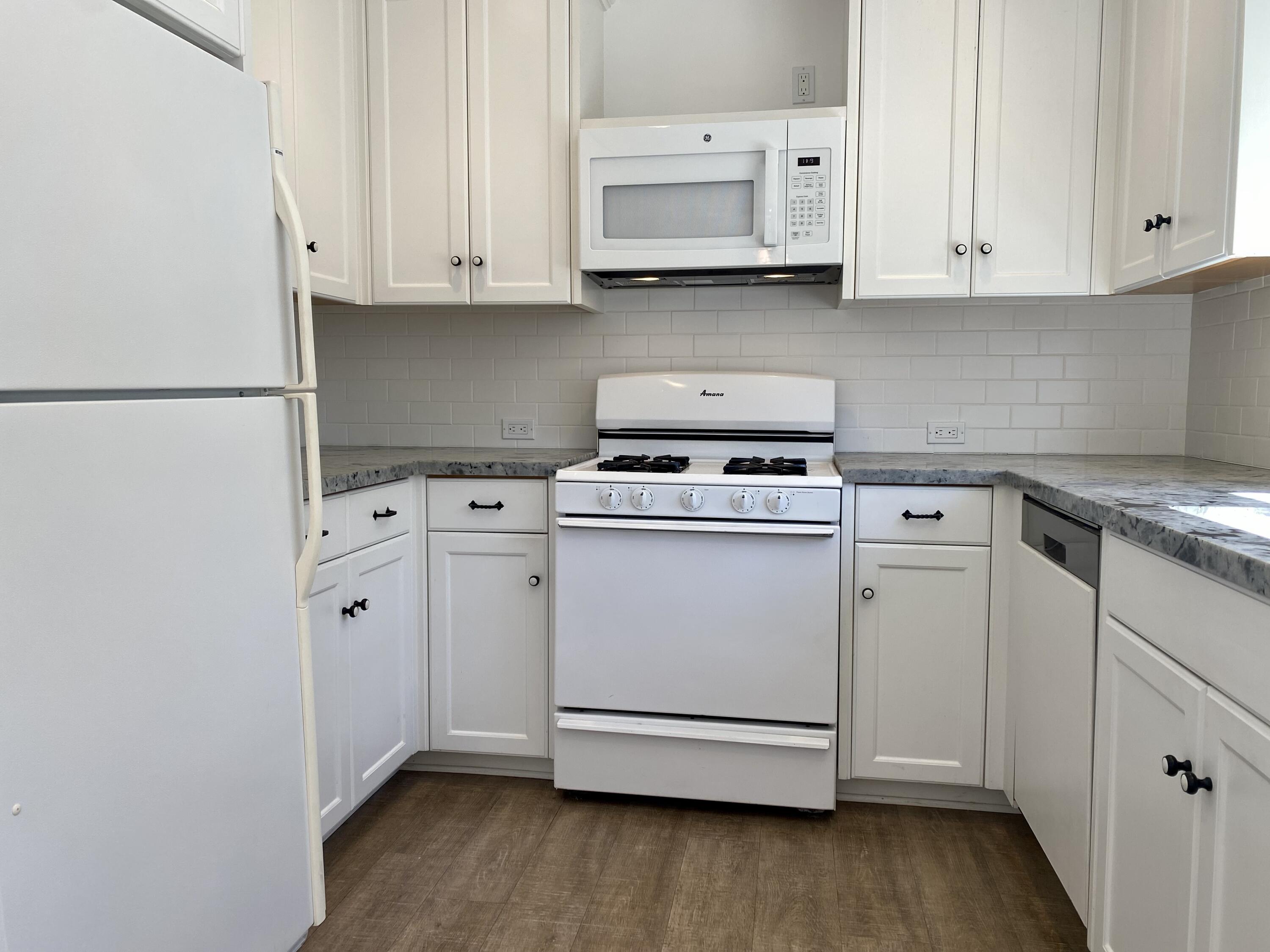 4854 8th Street Carpinteria, CA 93013 - Photo 7 of 22 a kitchen with cabinets appliances and wooden floor