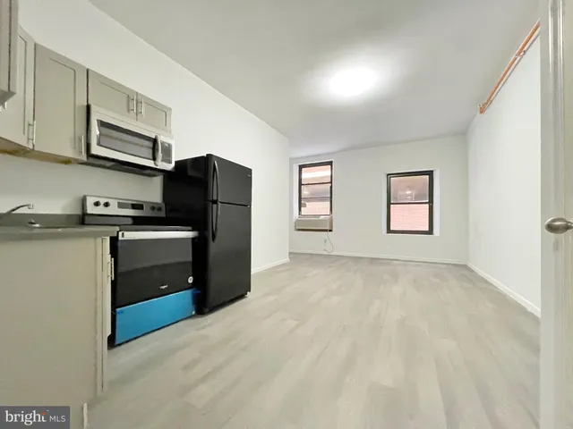 a kitchen with stainless steel appliances a refrigerator stove and sink