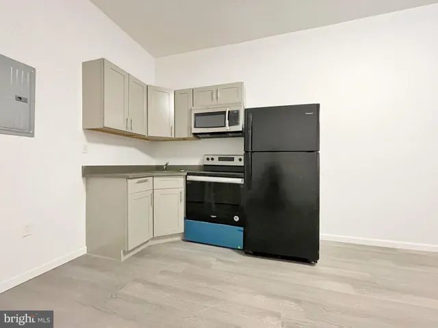 a kitchen with a refrigerator and a stove