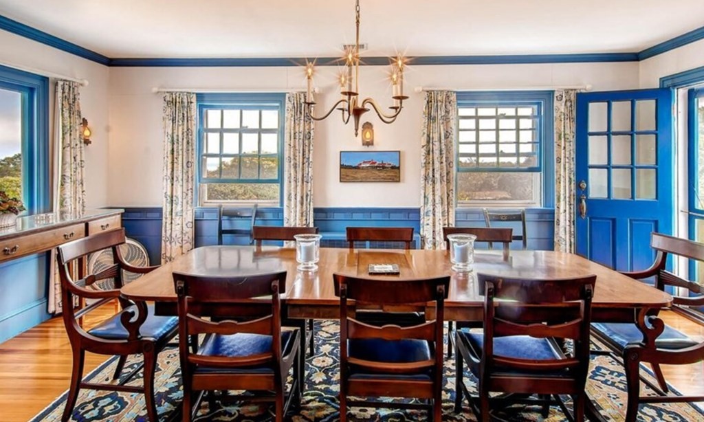 5 Wauompauque Trail, Unit 1 CH213 Chilmark, MA 02535 - Photo 3 of 8 a dining room with furniture a chandelier and window