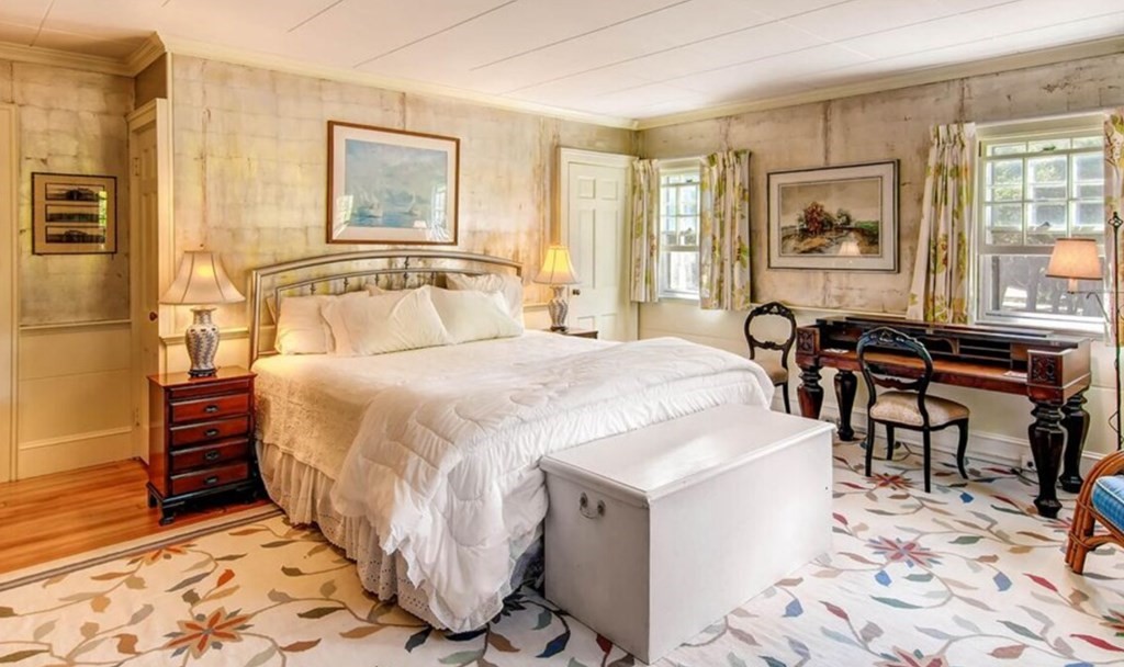 5 Wauompauque Trail, Unit 1 CH213 Chilmark, MA 02535 - Photo 4 of 8 a spacious bedroom with a bed a table and chair