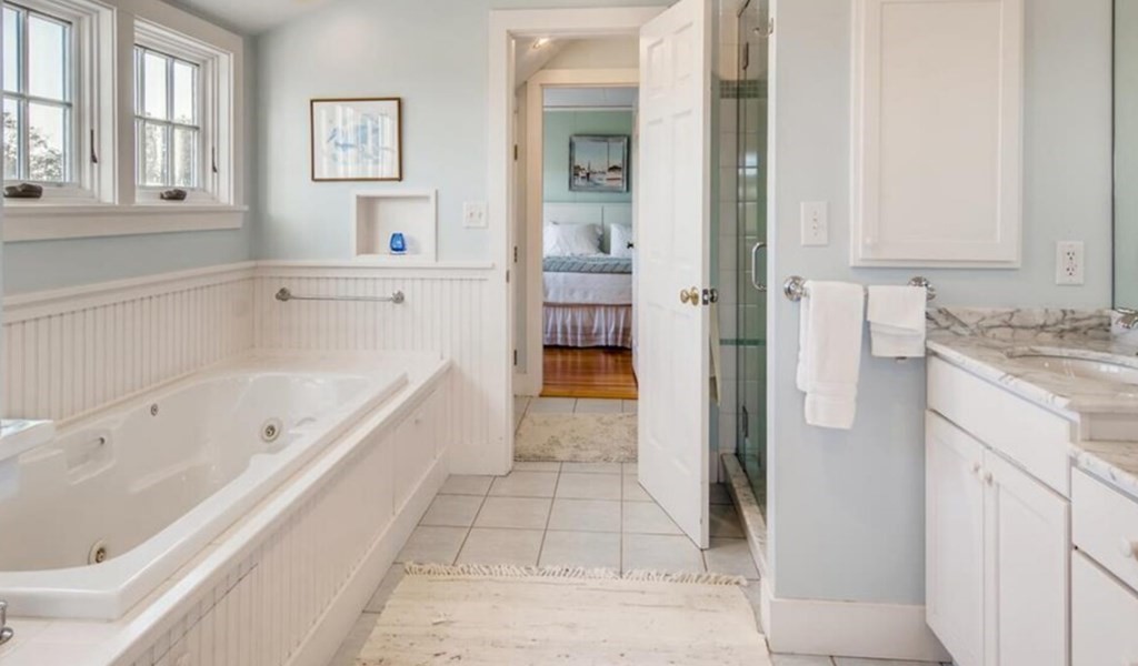 5 Wauompauque Trail, Unit 1 CH213 Chilmark, MA 02535 - Photo 8 of 8 a bathroom with a bathtub and a shower