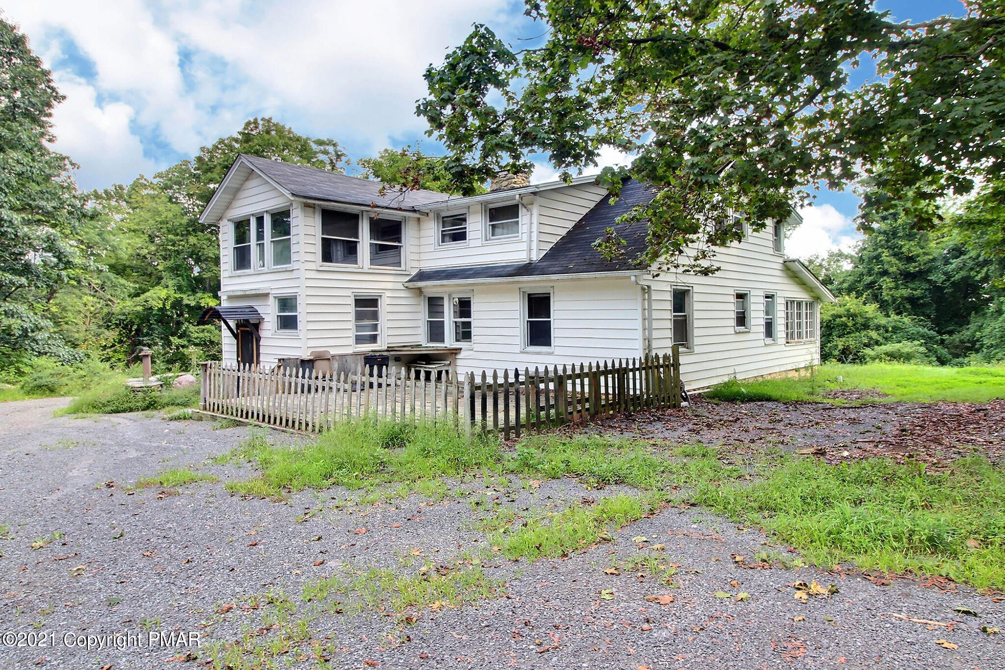 506 Red Rock Road Cresco, PA 18326 - Photo 3 of 26 a front view of a house with a garden and deck