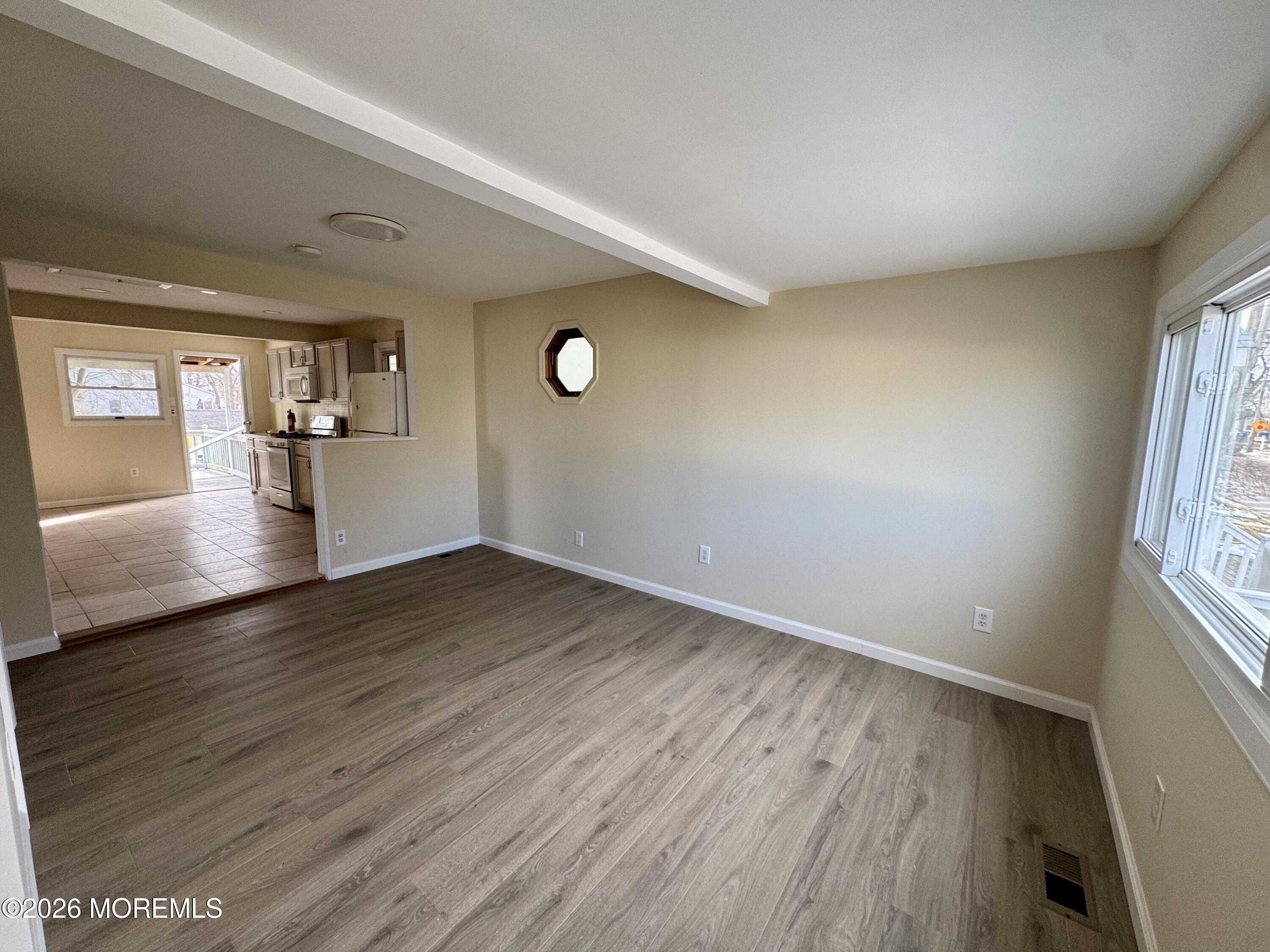 20 Bray Avenue Middletown, NJ 07748 - Photo 4 of 10 an empty room with wooden floor and windows