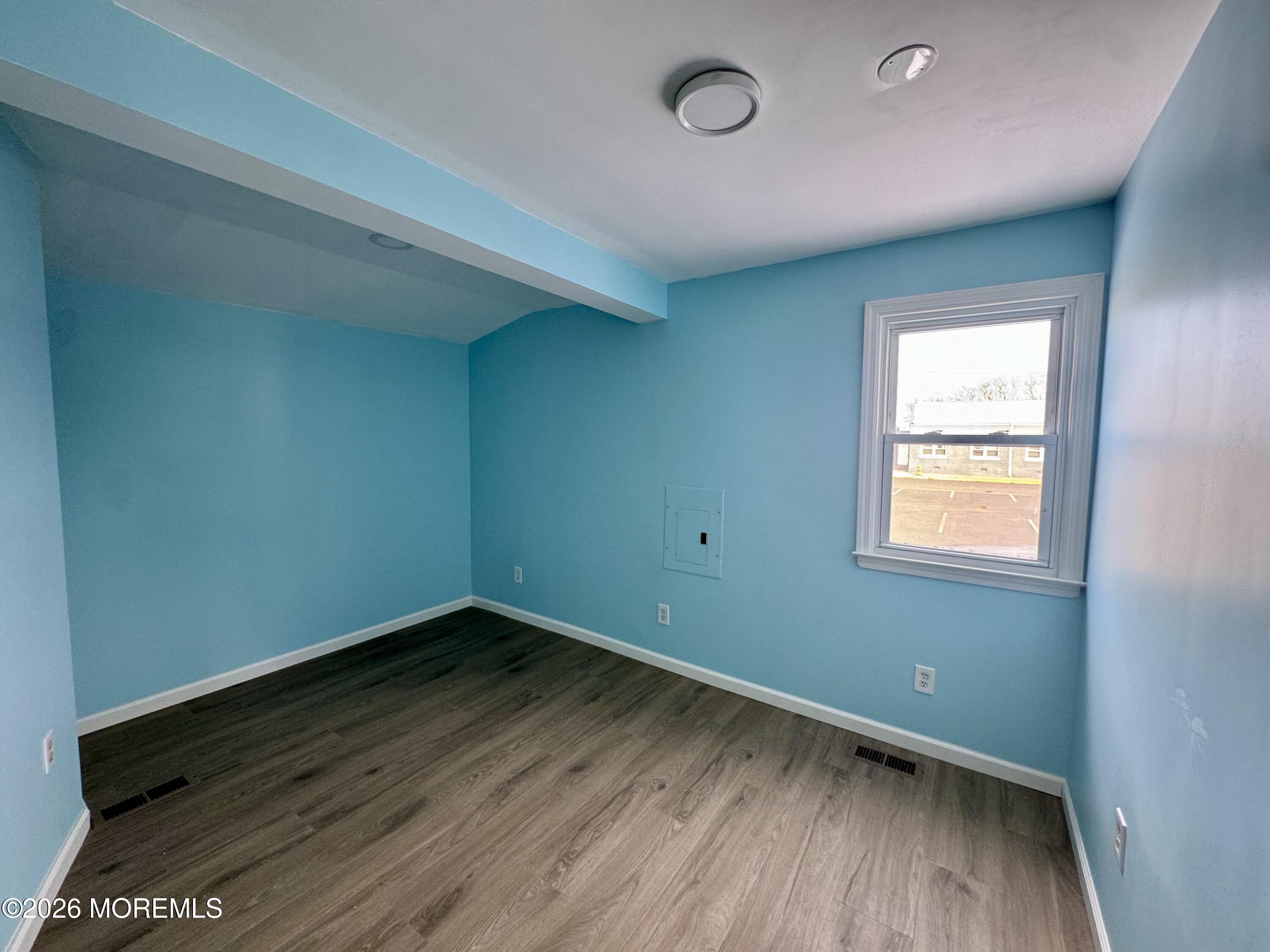 20 Bray Avenue Middletown, NJ 07748 - Photo 5 of 10 an empty room with wooden floor and windows