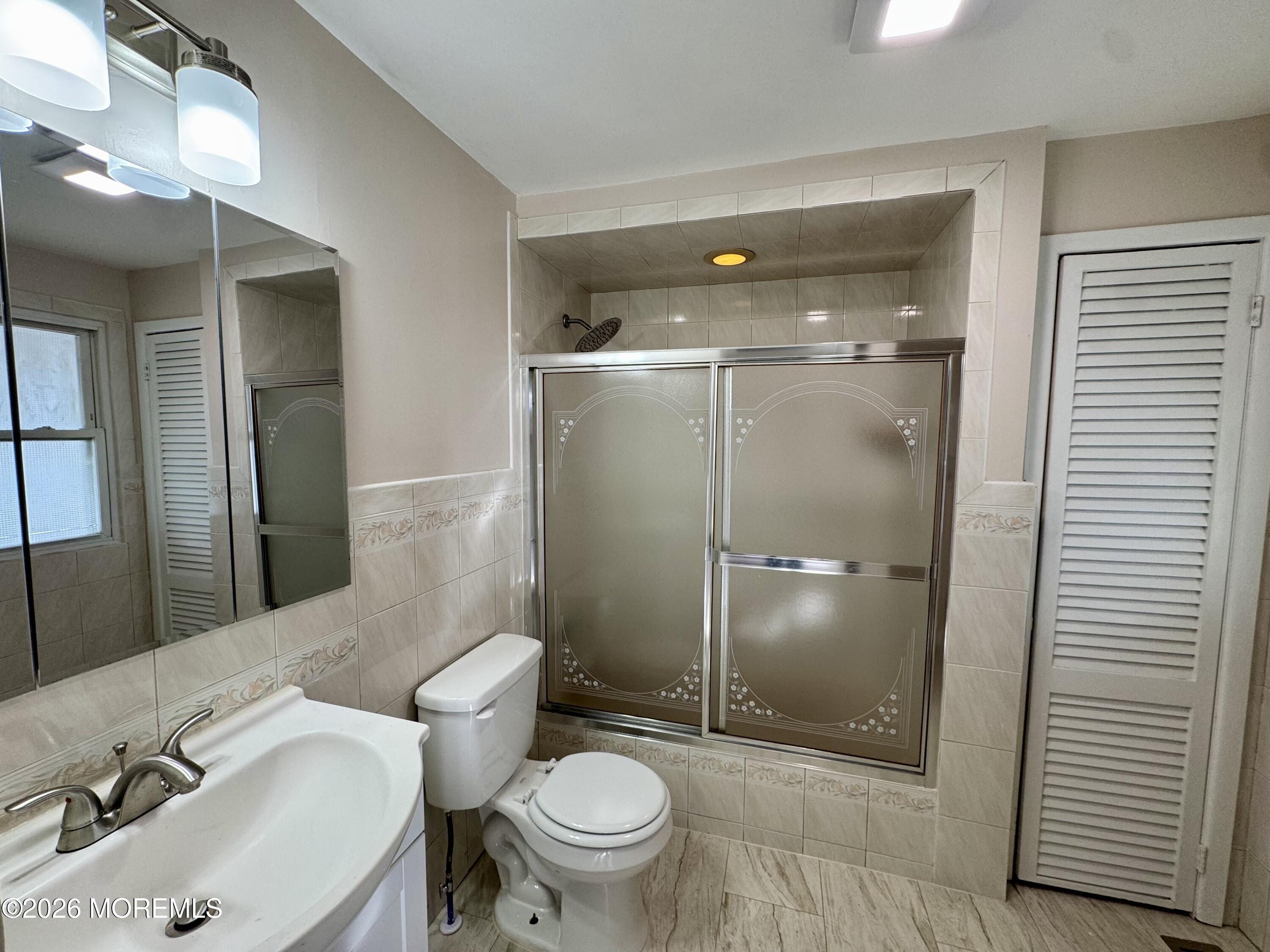 20 Bray Avenue Middletown, NJ 07748 - Photo 7 of 10 a bathroom with a sink and a mirror