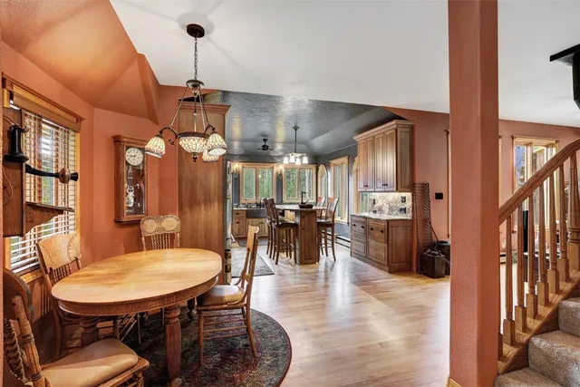 a dining room with furniture a chandelier and wooden floor