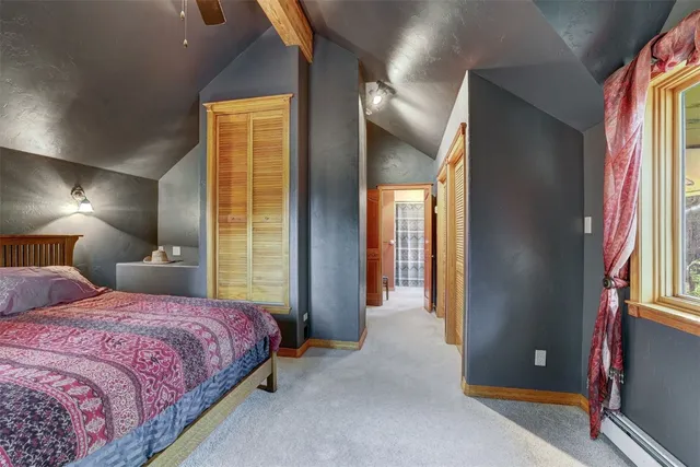 a bedroom with a bed and a night stand