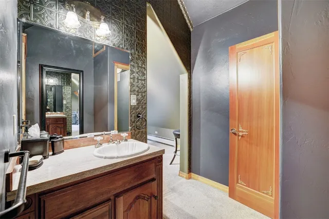 a bathroom with a sink a mirror and a shower