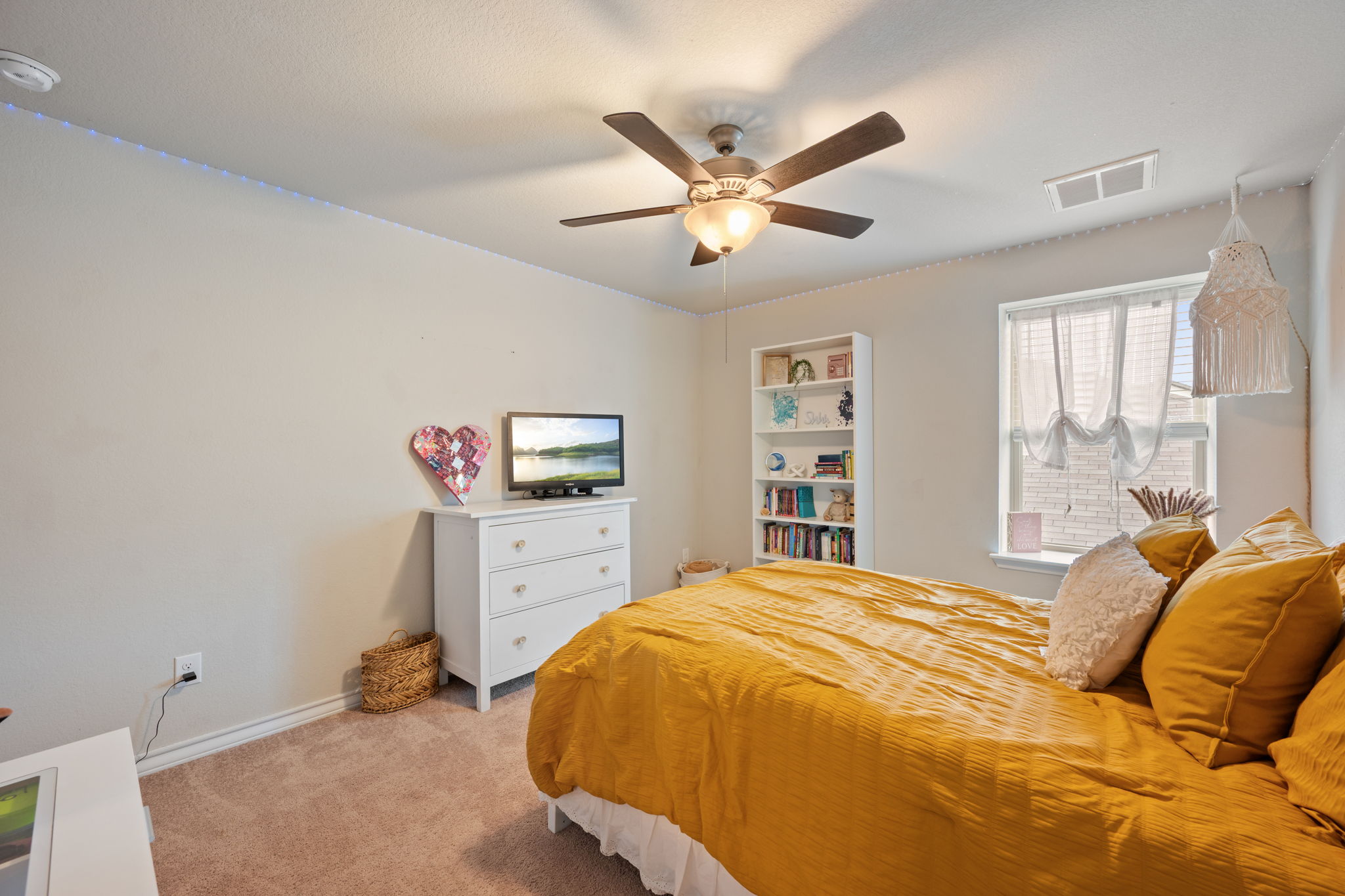 409 Limestone Road Liberty Hill, TX 78642 - Photo 24 of 35 a bedroom with a bed and a chandelier