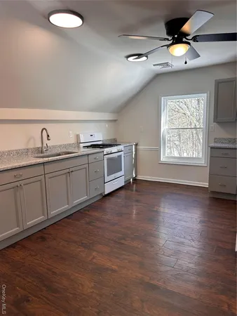 a spacious bathroom with a granite countertop sink and mirror