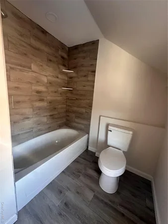 a bathroom with a toilet and a bathtub