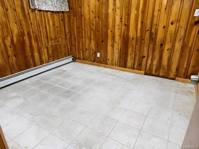 a view of an empty room with wooden fence