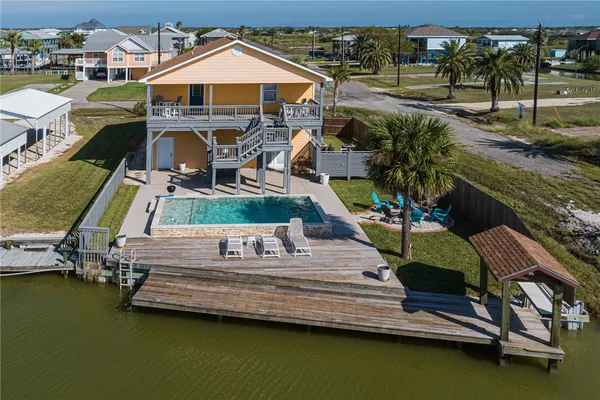 a view of swimming pool with outdoor seating and yard