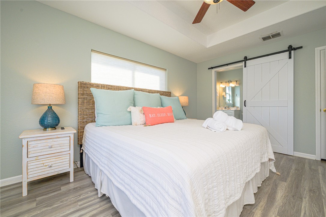 102 Ball Street Rockport, TX 78382 - Photo 28 of 40 a bedroom with a bed a window and lamp