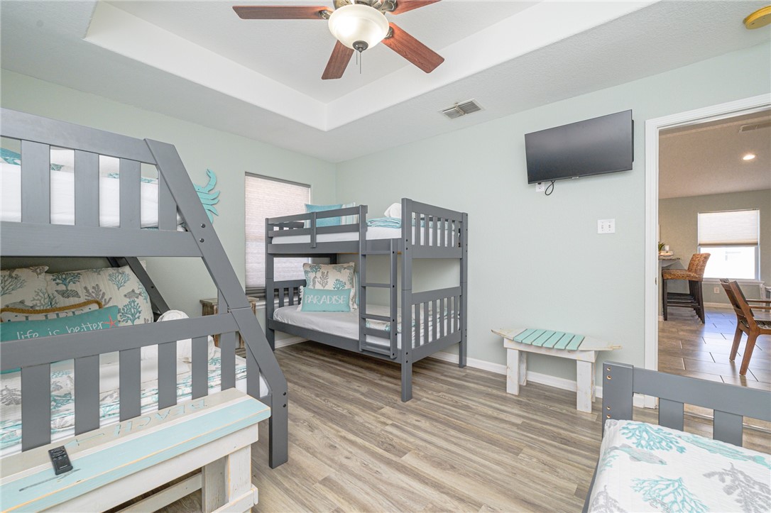 102 Ball Street Rockport, TX 78382 - Photo 32 of 40 a bedroom with furniture and a wooden floor