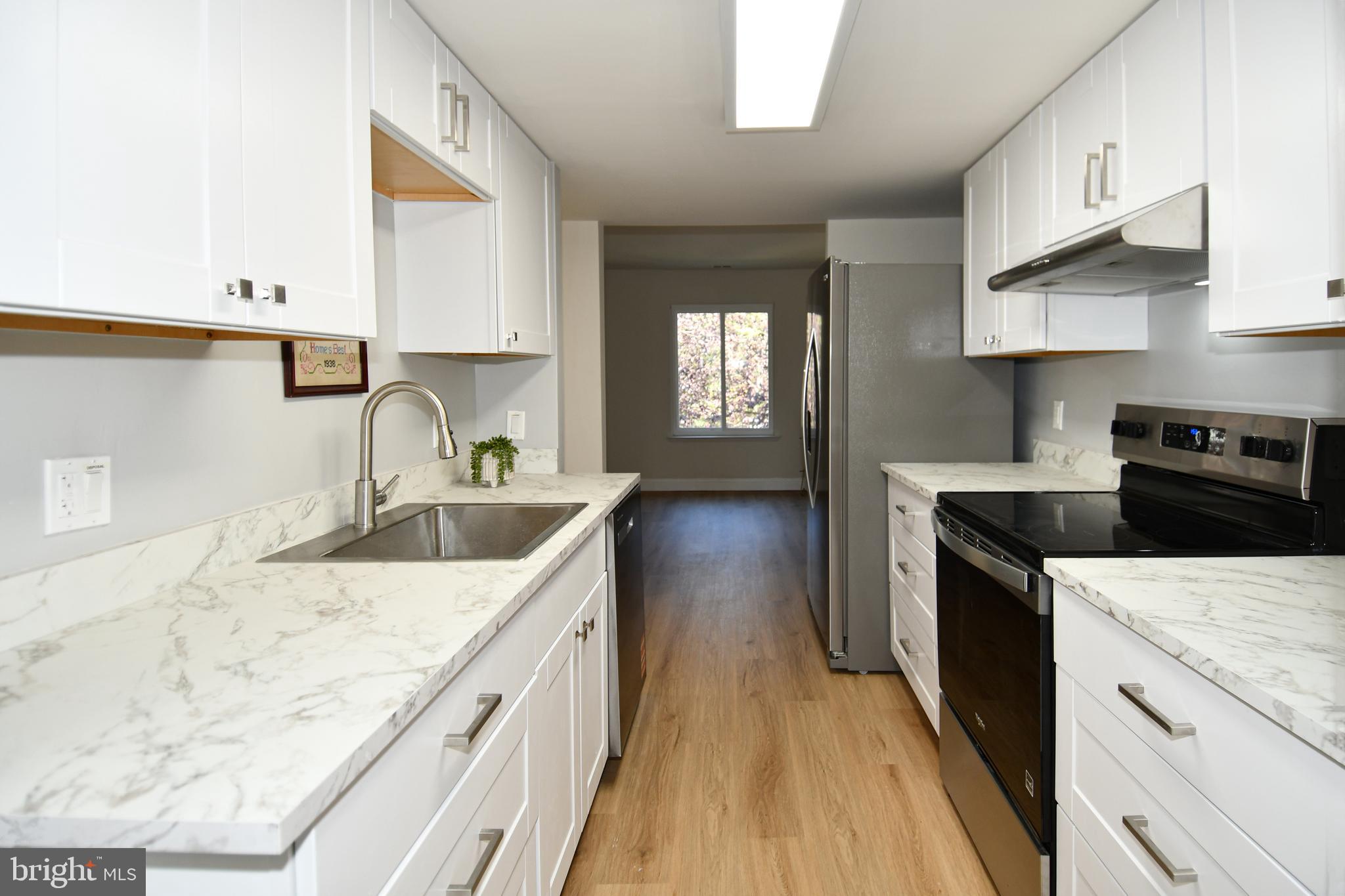 15003 Candover Court, Unit 281C Silver Spring, MD 20906 - Photo 16 of 42 a kitchen with stainless steel appliances granite countertop a sink stove and refrigerator