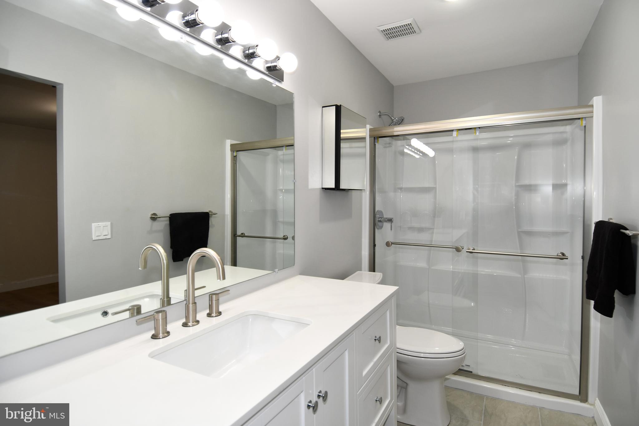 15003 Candover Court, Unit 281C Silver Spring, MD 20906 - Photo 29 of 42 a bathroom with a sink toilet and shower
