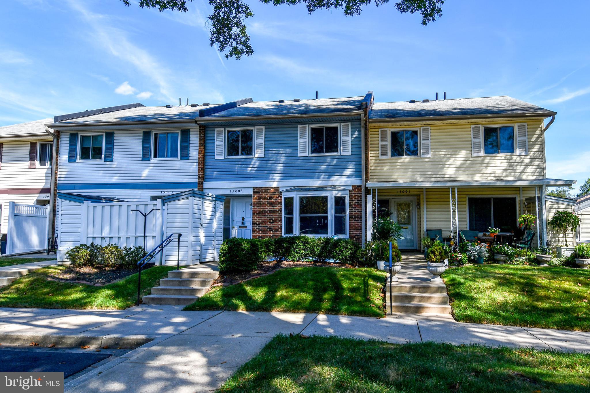 15003 Candover Court, Unit 281C Silver Spring, MD 20906 - Photo 39 of 42 a front view of a house with a yard table and chairs