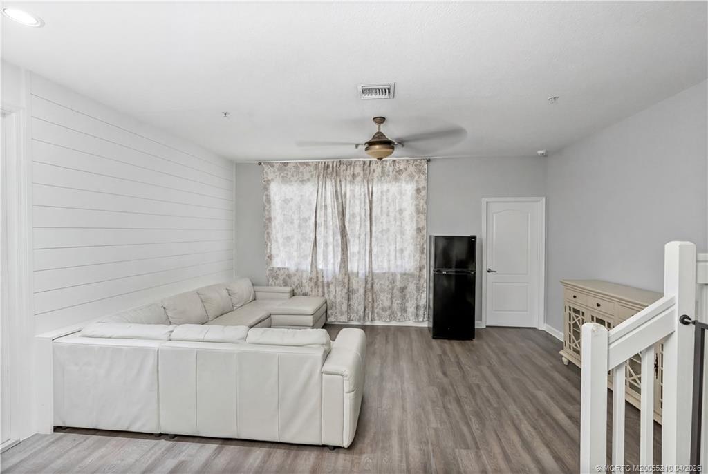 9456 Southwest Merlin Court Stuart, FL 34997 - Photo 12 of 23 a living room with furniture and a chandelier