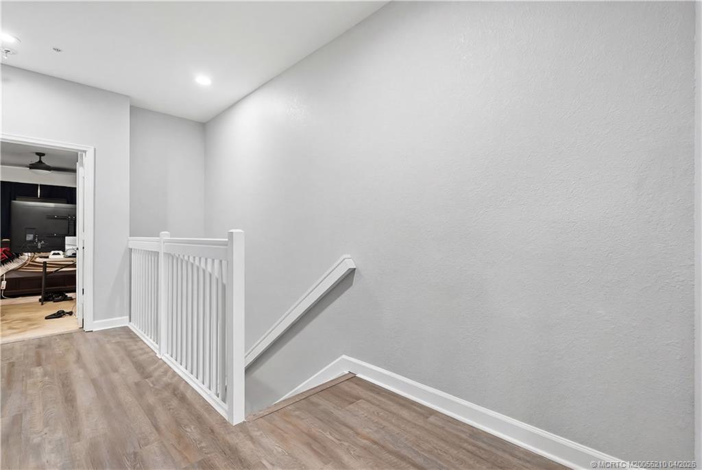 9456 Southwest Merlin Court Stuart, FL 34997 - Photo 13 of 23 a view of hallway with wooden floor