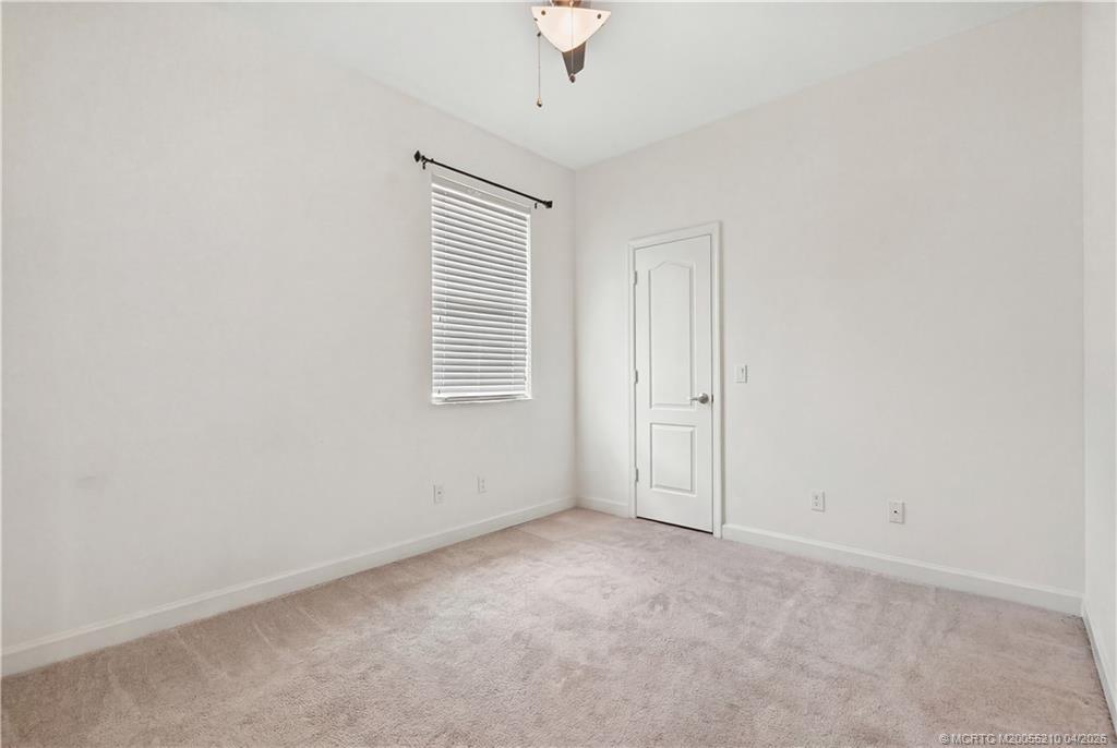 9456 Southwest Merlin Court Stuart, FL 34997 - Photo 18 of 23 an empty room with windows