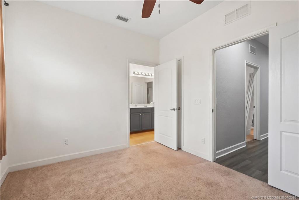 9456 Southwest Merlin Court Stuart, FL 34997 - Photo 19 of 23 an empty room with an entryway and wooden floor