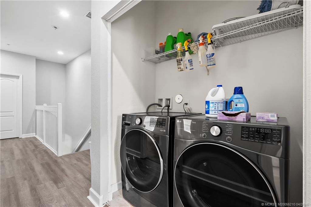 9456 Southwest Merlin Court Stuart, FL 34997 - Photo 22 of 23 a view of washer and dryer in a utility room