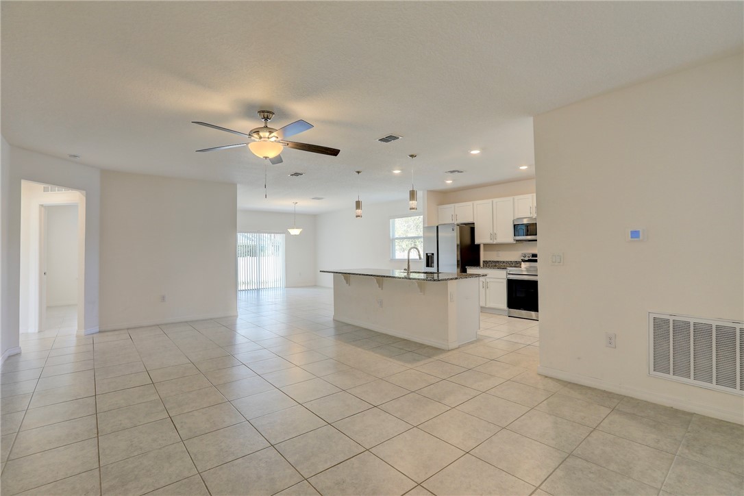 406 Easy Street Sebastian, FL 32958 - Photo 11 of 36 a view of kitchen with furniture and refrigerator