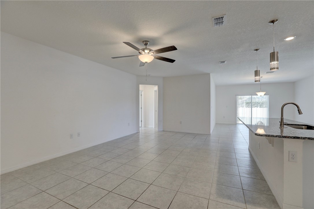 406 Easy Street Sebastian, FL 32958 - Photo 12 of 36 a view of a kitchen with a sink and a chandelier fan