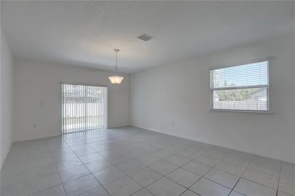 a kitchen with stainless steel appliances granite countertop a sink a stove a refrigerator and a counter top space