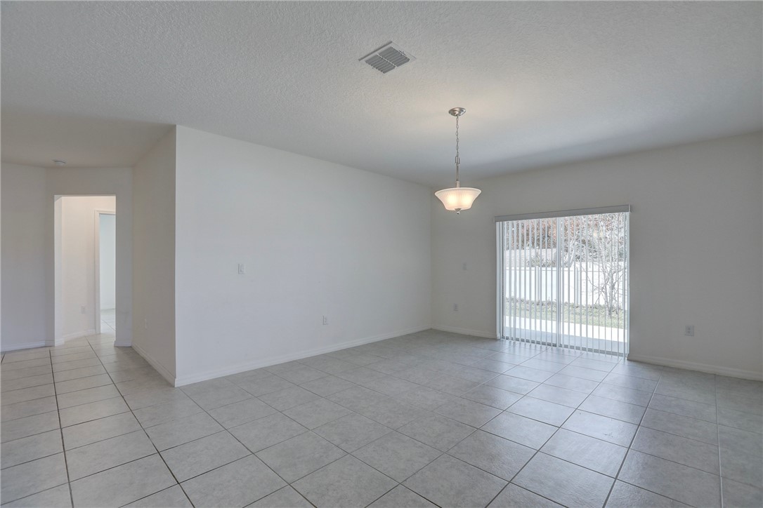 406 Easy Street Sebastian, FL 32958 - Photo 14 of 36 an empty room with fan and windows