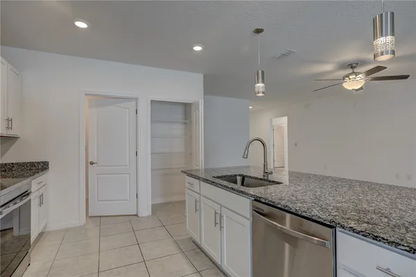 a bathroom with a granite countertop sink a mirror and shower