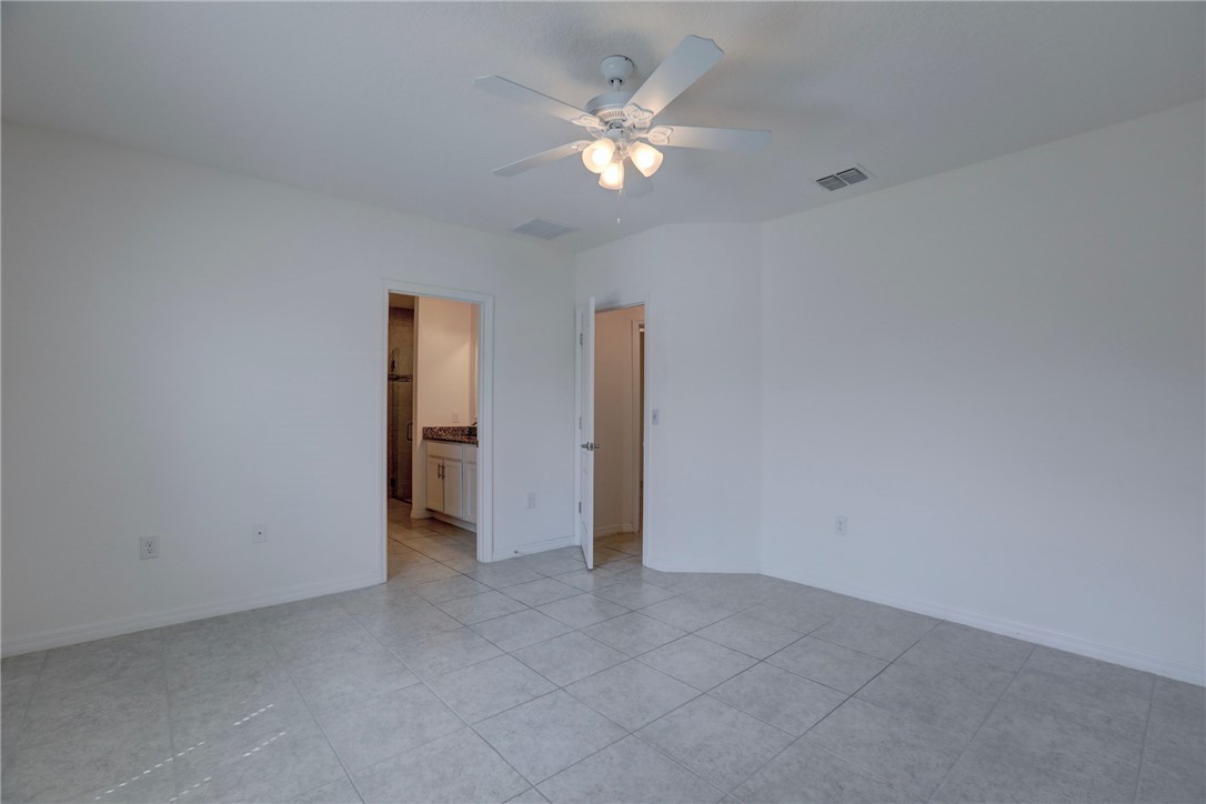 406 Easy Street Sebastian, FL 32958 - Photo 24 of 36 a view of an empty room with a ceiling fan
