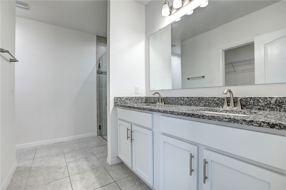 406 Easy Street Sebastian, FL 32958 - Photo 25 of 36 a bathroom with a granite countertop sink and a mirror