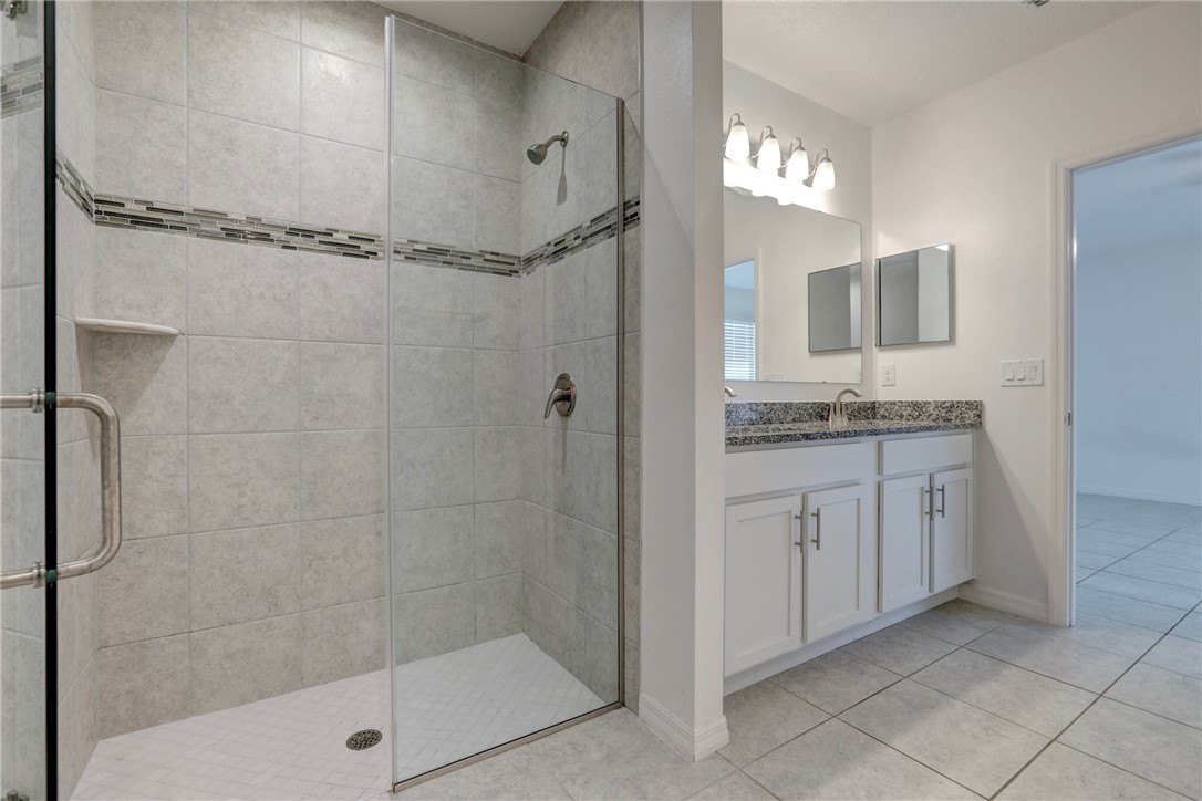 406 Easy Street Sebastian, FL 32958 - Photo 26 of 36 a bathroom with a granite countertop sink a mirror and shower