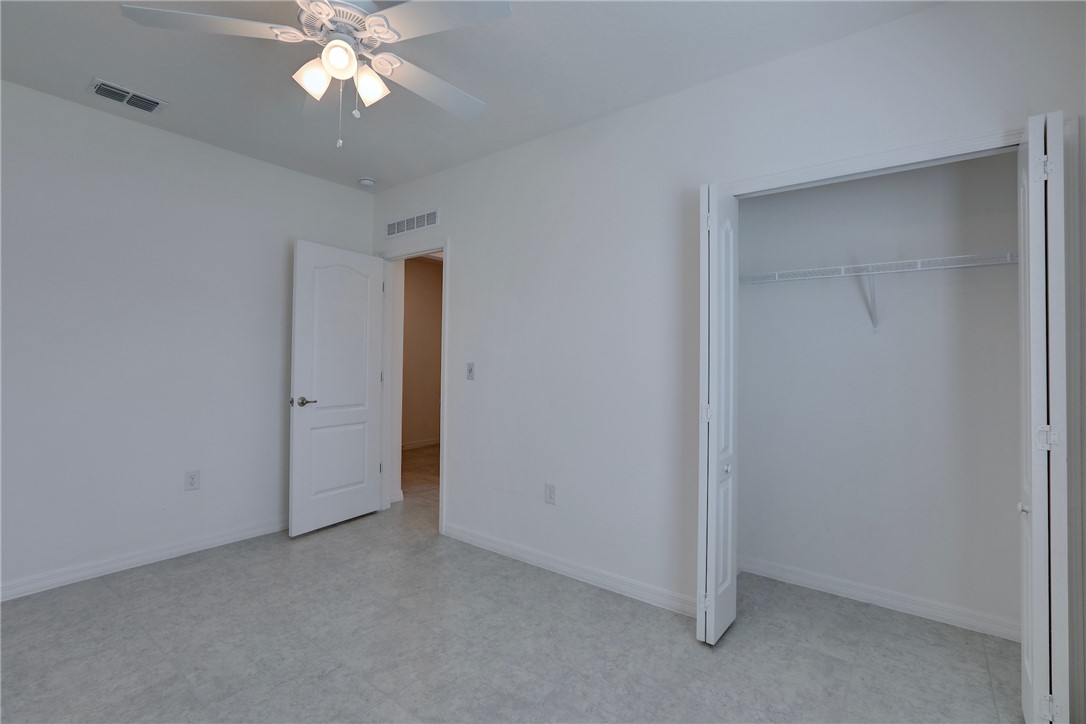 406 Easy Street Sebastian, FL 32958 - Photo 31 of 36 an empty room with a chandelier fan and a chandelier fan