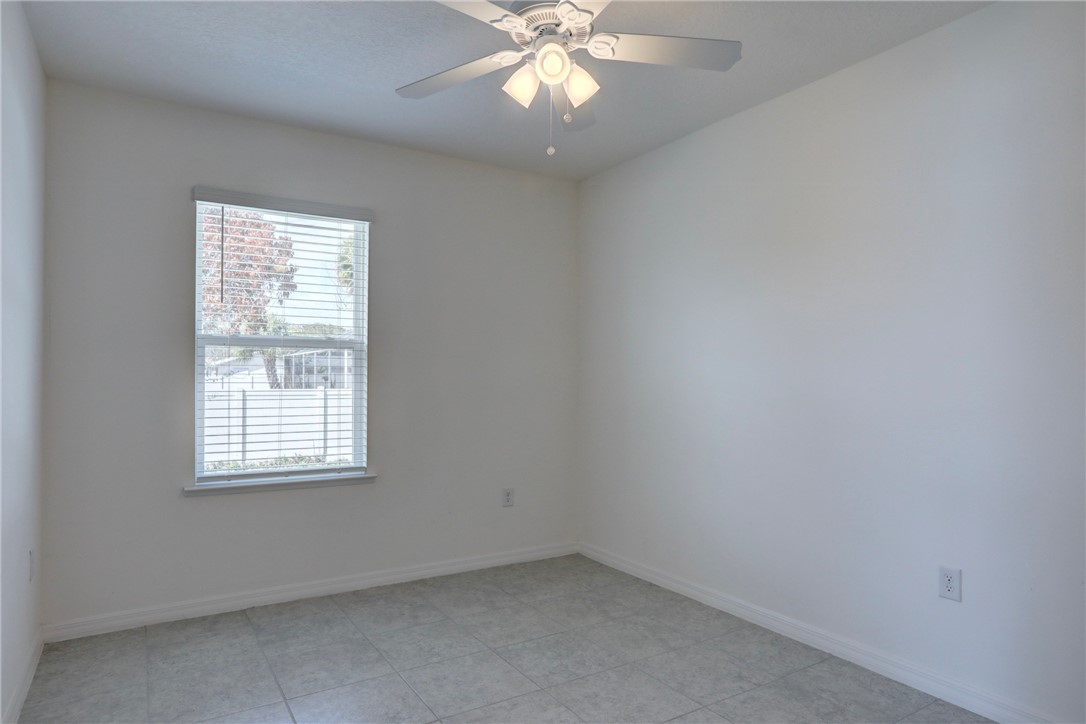 406 Easy Street Sebastian, FL 32958 - Photo 32 of 36 an empty room with a window and a fan