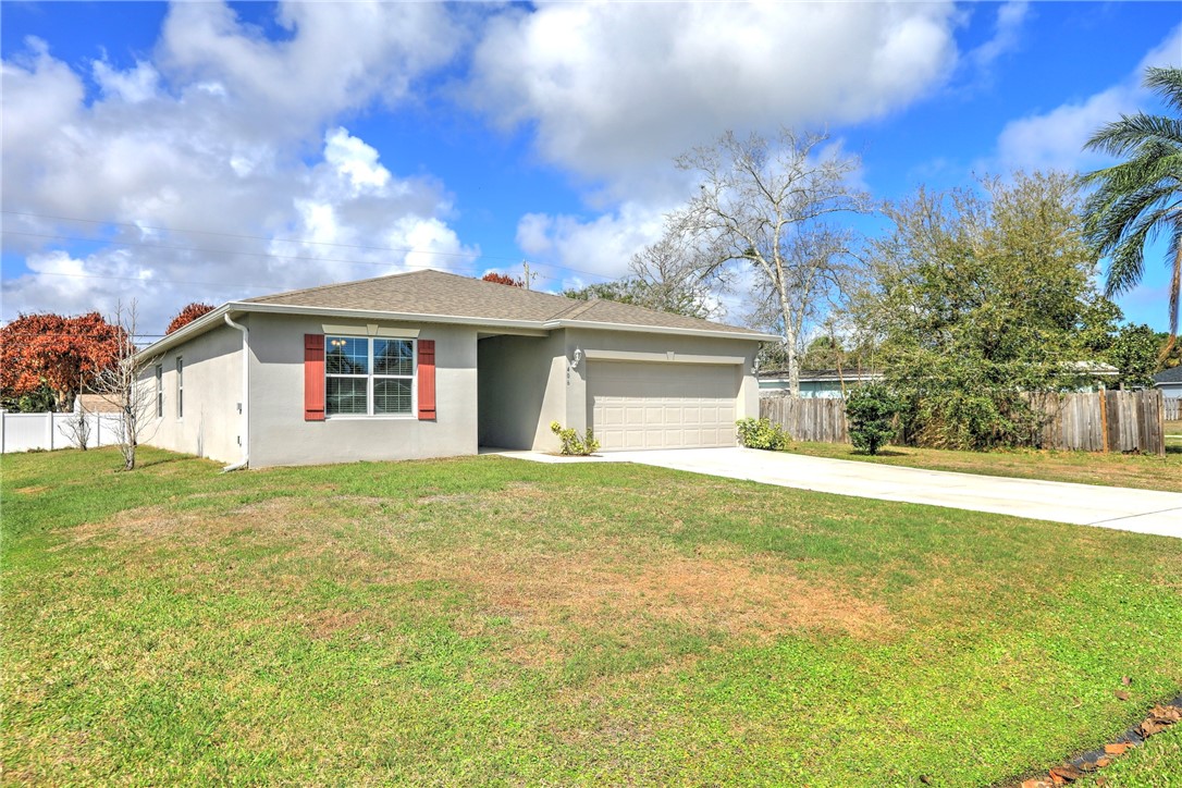 406 Easy Street Sebastian, FL 32958 - Photo 4 of 36 a front view of a house with a garden