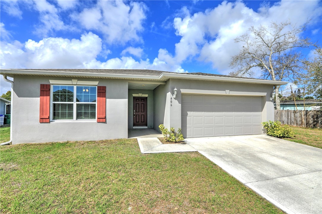 406 Easy Street Sebastian, FL 32958 - Photo 6 of 36 a front view of a house with a yard and garage