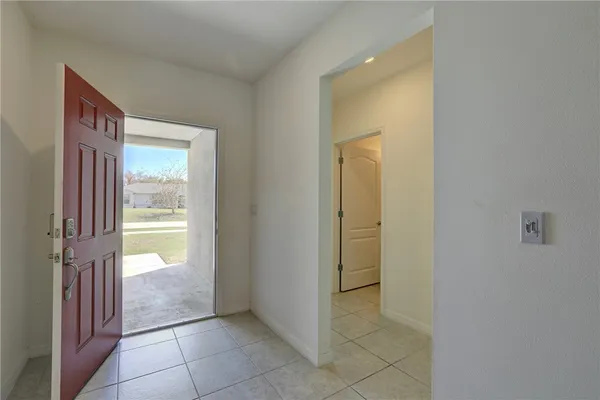 an empty room with fan and windows