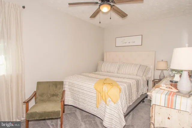 a bedroom with a bed and lamp