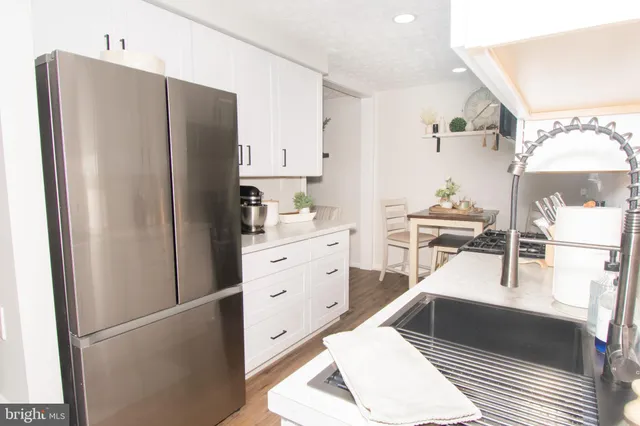 a kitchen with stainless steel appliances a refrigerator sink and cabinets